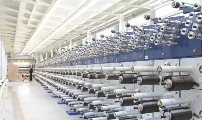 Carbon fibre production line, spools running the length of the hall