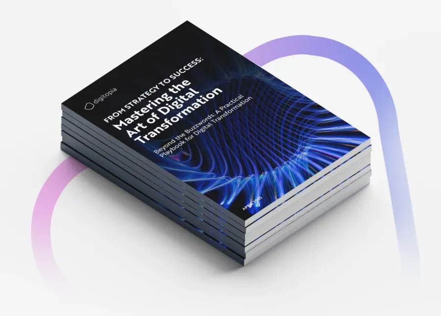 A stack of printed copies of Mastering the Art of Digital Transformation seen from above.