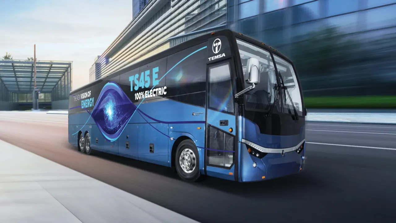 A TEMSA TS45 E all-electric coach in “the new vision of energy” livery on a city road.