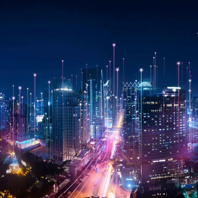 The e-book’s cover artwork: a city at night seen from above, its streets and towers lit in blue and violet with points of light rising above them.